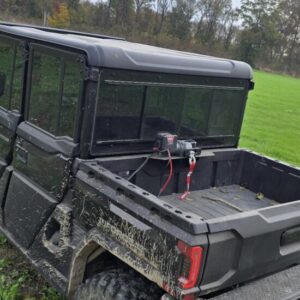 Off-road vehicle with empty truck bed.
